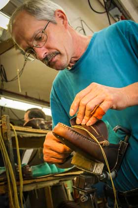 Rancourt & Co. employee hand sewing.