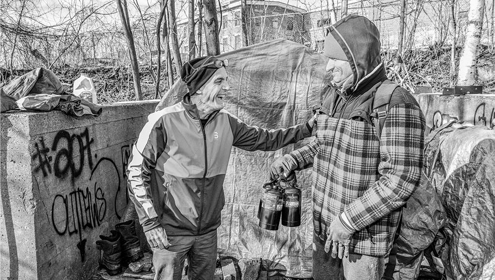 Dan Campbell has a conversation with local homeless.